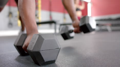 Close-up-of-a-person-lifting-heavy-dumbbells-at-the-gym