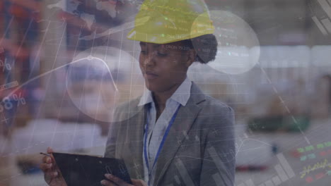 Animation-of-financial-data-processing-over-african-american-woman-using-tablet-in-warehouse