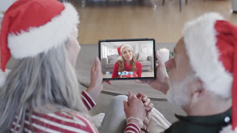 Happy-caucasian-daughter-and-senior-parents-having-christmas-tablet-video-call,-slow-motion