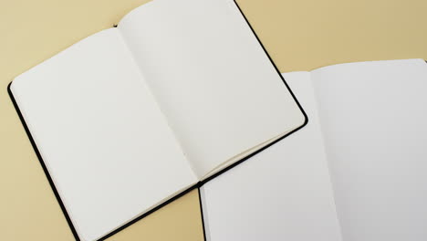 Video-of-books-with-white-blank-pages-and-copy-space-on-yellow-background