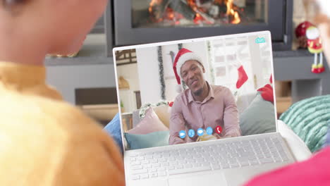 Happy-diverse-couple-and-senior-male-friend-having-christmas-laptop-video-call,-slow-motion