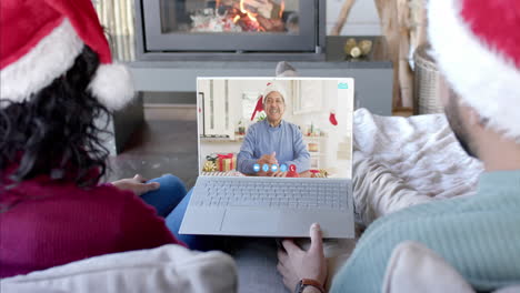 Happy-diverse-couple-and-senior-father-having-christmas-laptop-video-call,-slow-motion