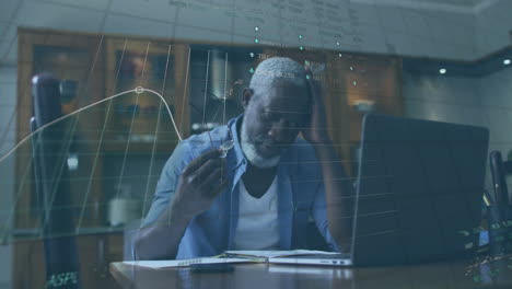 Animation-of-financial-data-processing-over-senior-african-american-man-using-laptop