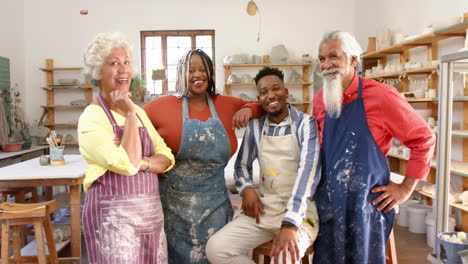 Happy-diverse-group-of-potters-smiling-in-pottery-studio