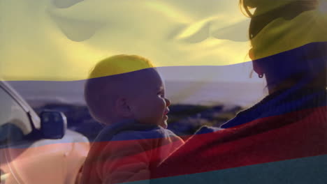 Animation-of-colombian-flag-over-caucasian-mother,-father-and-child-on-sunny-beach