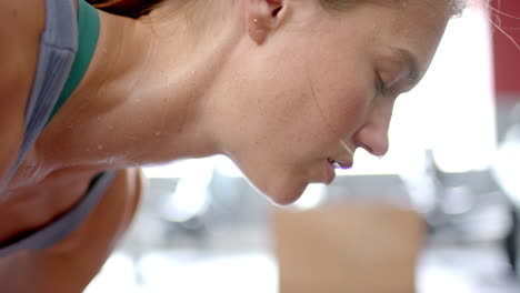 Close-up-of-a-young-Caucasian-woman-exercising-intensely-at-the-gym