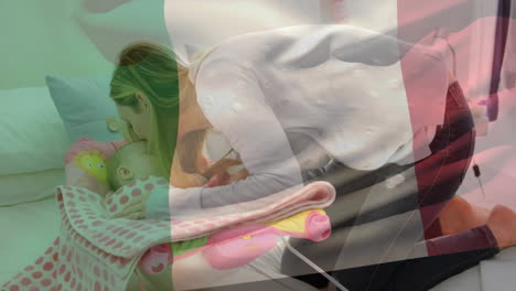 Animation-of-italian-flag-over-happy-caucasian-mother-kissing-baby-lying-in-sunny-room