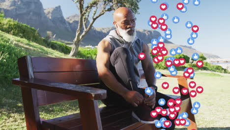 Animation-of-social-media-icons-over-senior-african-american-man-sitting-on-bench
