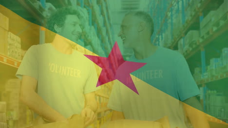 Animation-of-flag-of-french-guiana-over-happy-caucasian-male-volunteers-high-fiving-in-warehouse