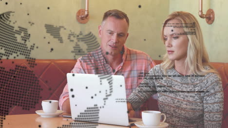 Animation-of-global-network-and-data-over-caucasian-male-and-female-colleague-using-laptop-at-cafe