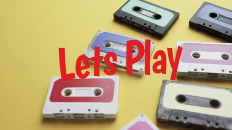 Animation-of-lets-play-text-over-tape-on-yellow-background