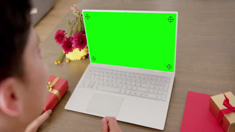 Caucasian-woman-using-laptop-with-copy-space-on-green-screen