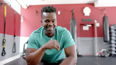 Fit-African-American-man-smiling-in-a-gym