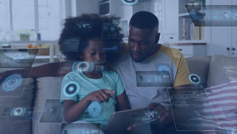 Animation-of-data-over-happy-african-american-father-and-daughter-using-tablet-relaxing-at-home