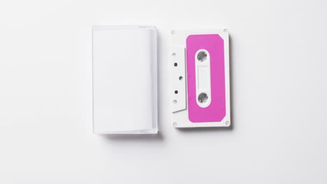 Video-of-retro-tape-with-pink-label-and-clear-box-with-copy-space-on-white-background