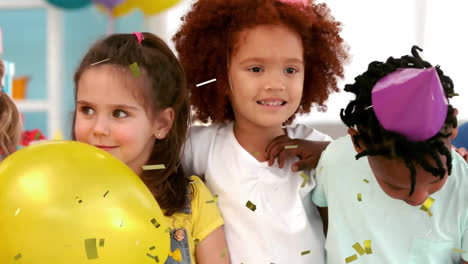Animation-of-gold-confetti-over-happy-diverse-children-celebrating-at-birthday-party