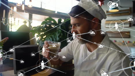Animation-of-network-of-connections-with-icons-over-caucasian-baker-in-kitchen