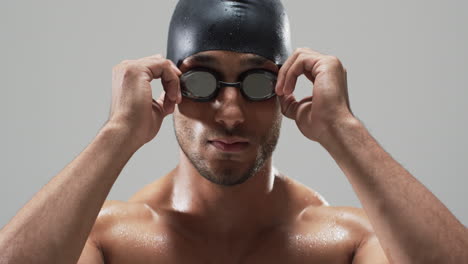 Focused-swimmer-adjusting-goggles-before-a-race