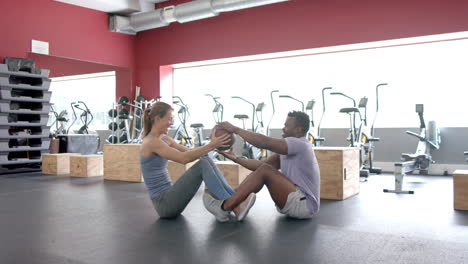 Fit-young-Caucasian-woman-and-African-American-man-exercising-at-the-gym