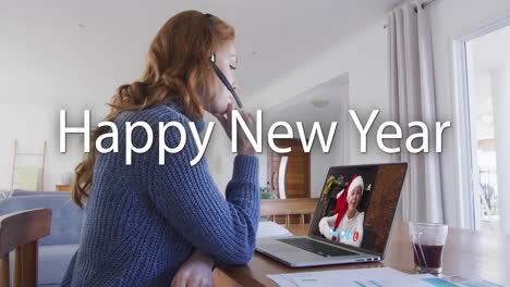 Animation-of-happy-new-year-text-over-caucasian-woman-on-laptop-video-call-at-christmas