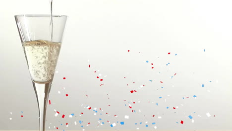 Animation-of-confetti-falling-over-champagne-glass