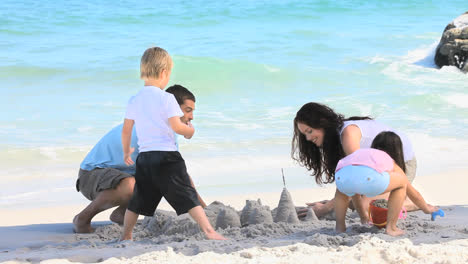 Happy-family-building-a-sand-castle