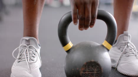 Close-up-of-athletic-shoes-and-a-kettlebell-at-the-gym
