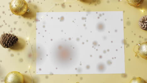 Animation-of-spots-of-light-over-white-paper-with-copy-space-and-christmas-decorations