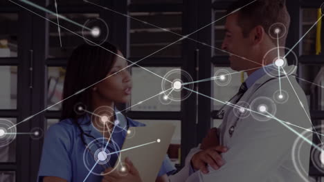 Animation-of-network-of-connections-over-diverse-male-and-female-doctors-discussing-work