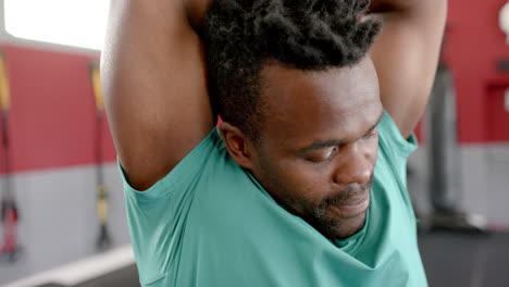 Fit-African-American-man-stretching-at-the-gym