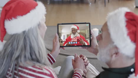 Happy-diverse-senior-couple-and-male-friend-having-christmas-tablet-video-call,-slow-motion
