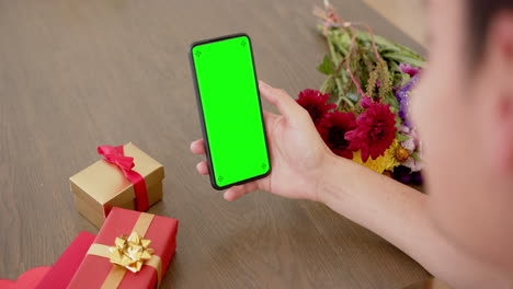 Caucasian-woman-holding-smartphone-with-copy-space-on-green-screen