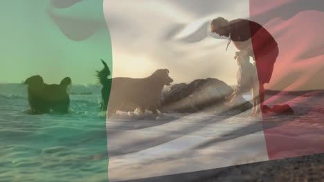 Animación-De-La-Bandera-Italiana-Sobre-Un-Padre-Caucásico-Y-Un-Niño-Con-Perros-En-Una-Playa-Soleada