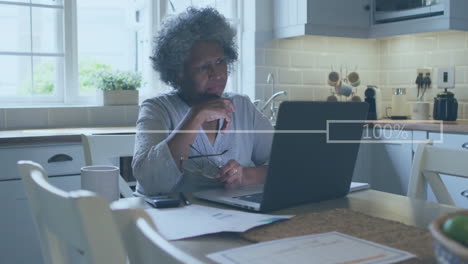 Animation-of-financial-data-processing-over-senior-african-american-woman-using-laptop