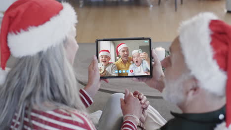 Caucasian-grandparents,-father-and-sons-having-christmas-tablet-video-call,-slow-motion