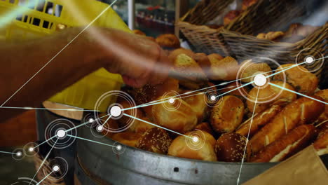 Animation-of-network-of-connections-over-caucasian-man-picking-bread-in-bakery