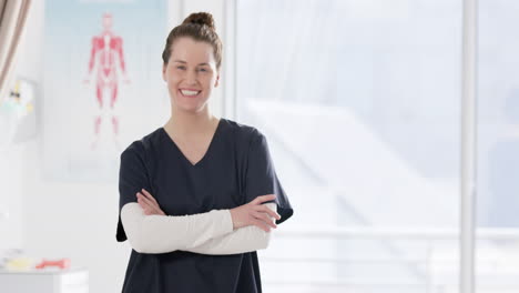 Portrait-of-happy-caucasian-female-doctor-in-hospital-with-copy-space,-slow-motion