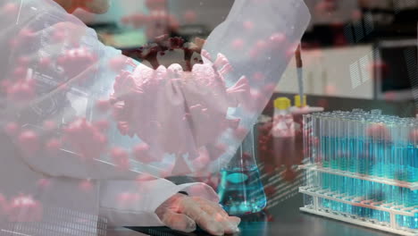 Animation-of-virus-cells-over-caucasian-female-scientist-working-in-lab