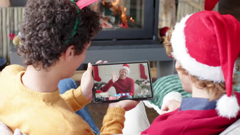 Happy-diverse-male-friends-having-christmas-tablet-video-call,-slow-motion