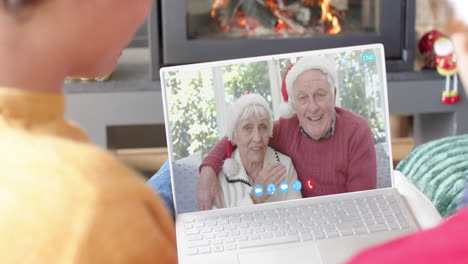 Glückliches-Kaukasisches-Paar-Und-ältere-Eltern-Mit-Weihnachtlichem-Laptop-Videoanruf,-Zeitlupe