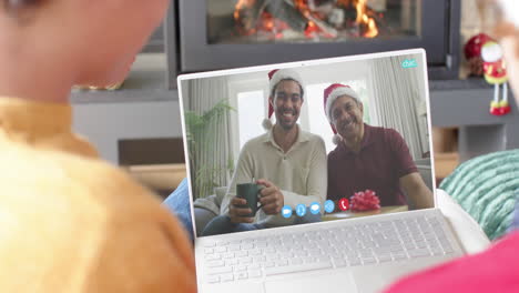 Happy-diverse-father,-son-and-male-friends-having-christmas-laptop-video-call,-slow-motion
