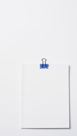 Video-of-books-with-white-blank-pages-and-blue-paper-clip-with-copy-space-on-white-background