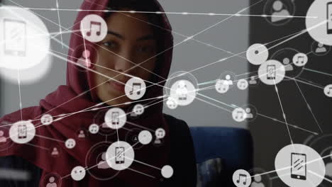 Animation-of-network-of-connections-with-icons-over-biracial-woman-in-hijab