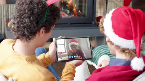 Three-happy-diverse-male-friends-having-christmas-tablet-video-call,-slow-motion