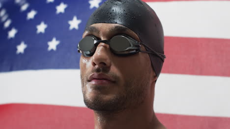 Young-biracial-athlete-swimmer-in-swim-gear-poses-confidently