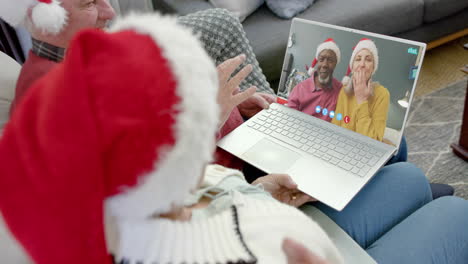Two-happy-diverse-senior-couples-having-christmas-laptop-video-call,-slow-motion