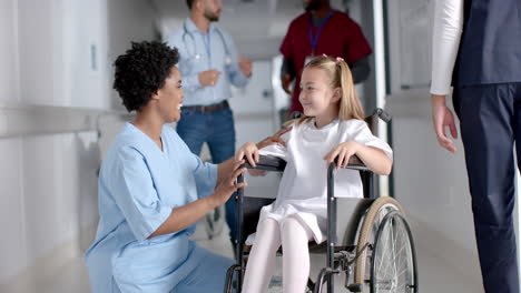 Nurse-assists-a-Caucasian-girl-in-a-wheelchair-at-the-hospital