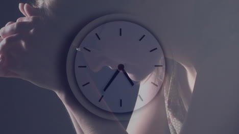 Animation-of-clock-moving-fast-over-caucasian-woman-praying