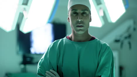 Portrait-of-caucasian-male-surgeon-wearing-surgical-gown-in-operating-theatre,-slow-motion