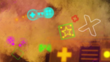 Animation-Von-Bunten-Videospiel-Controllern-Und-Symbolen-über-Gelben-Und-Orangefarbenen-Pulverpartikeln